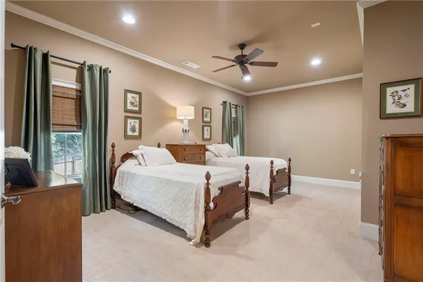 a spacious bedroom with a bed and large windows