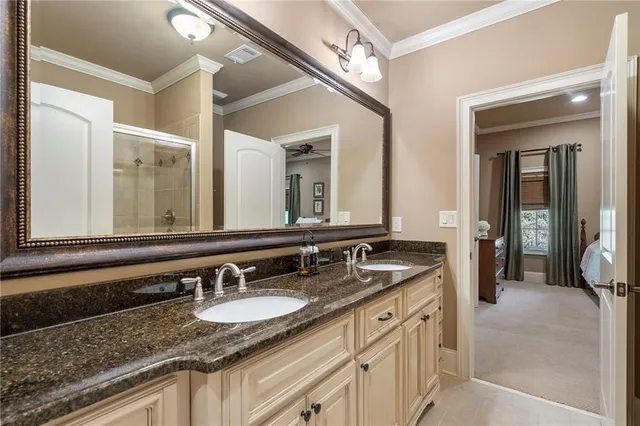 a bathroom with a granite countertop sink double and mirror
