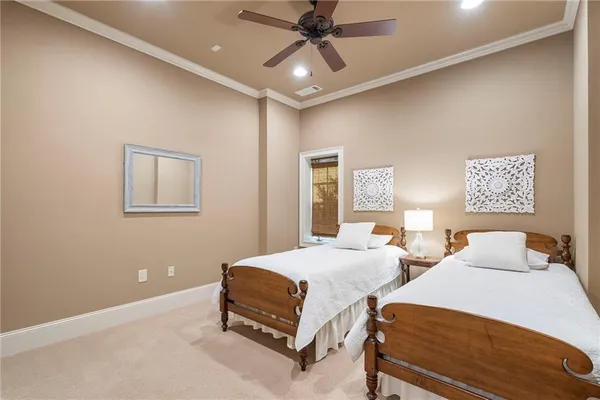 a bedroom with two beds and painting on the wall