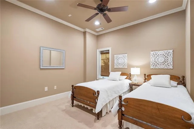 a bedroom with two beds and painting on the wall