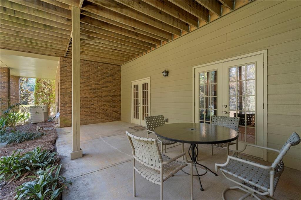 2472 Ballantrae Circle Cumming, GA 30041 - Photo 32 of 41 a backyard of a house with table and chairs