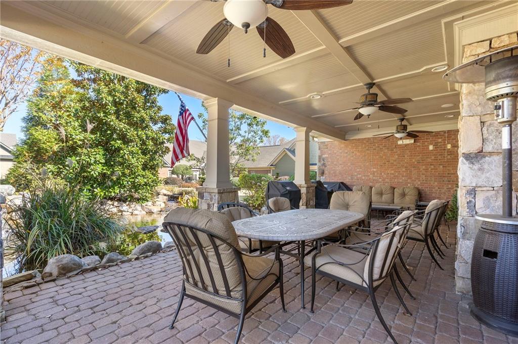 2472 Ballantrae Circle Cumming, GA 30041 - Photo 37 of 41 a view of a patio with a table and chairs and potted plants