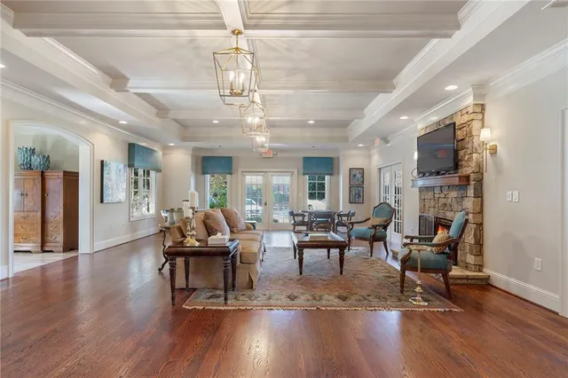 a living room with fireplace furniture and a wooden floor