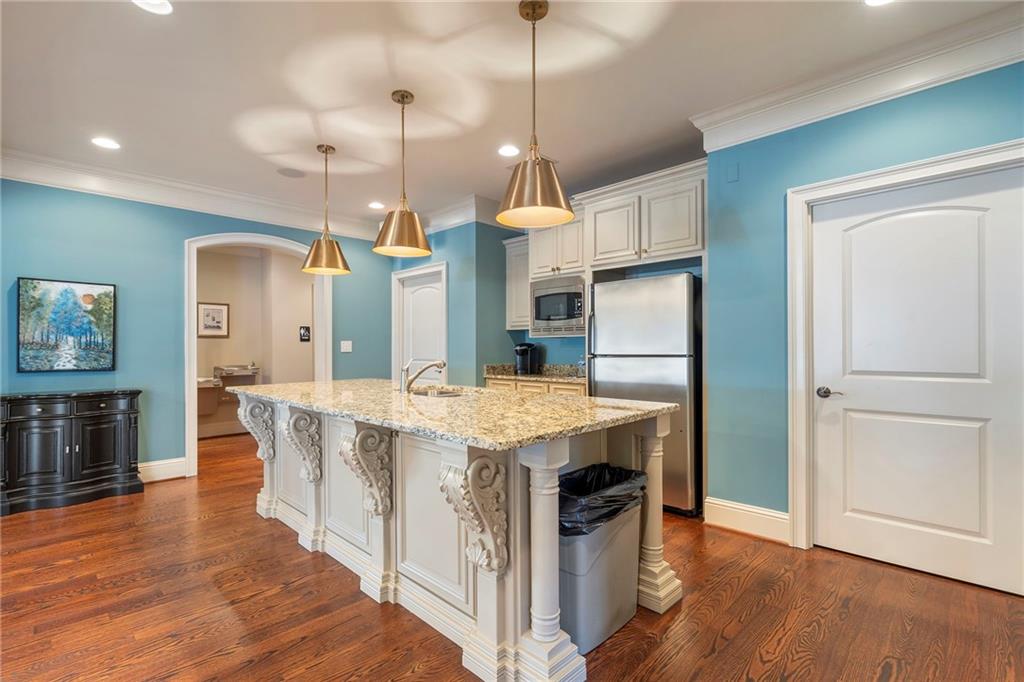 2472 Ballantrae Circle Cumming, GA 30041 - Photo 39 of 41 a kitchen that has a lot of counter space and wooden floor