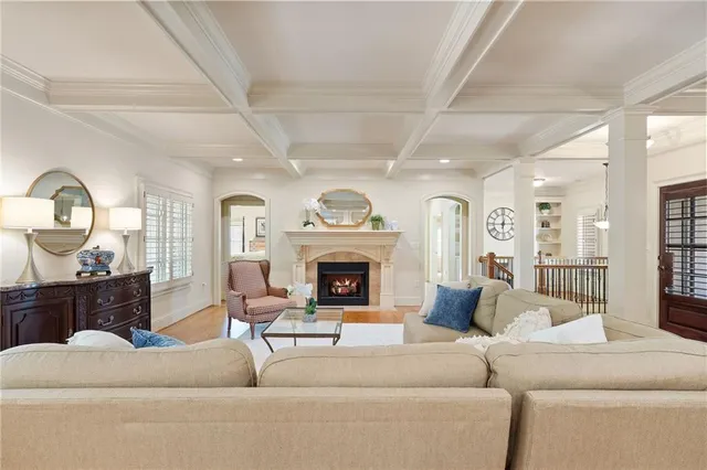 a living room with furniture a fireplace and a large window