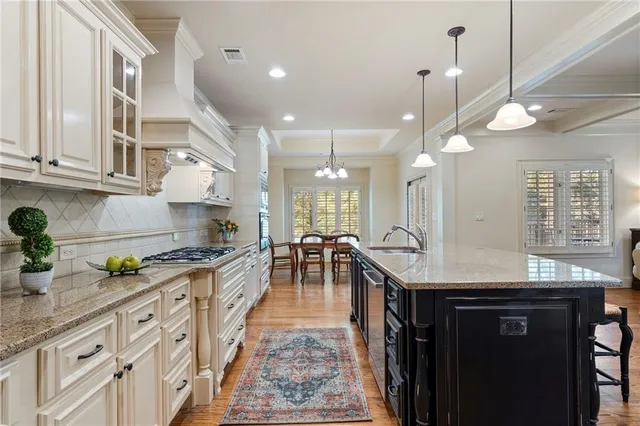 a kitchen with lots of counter space and wooden floor