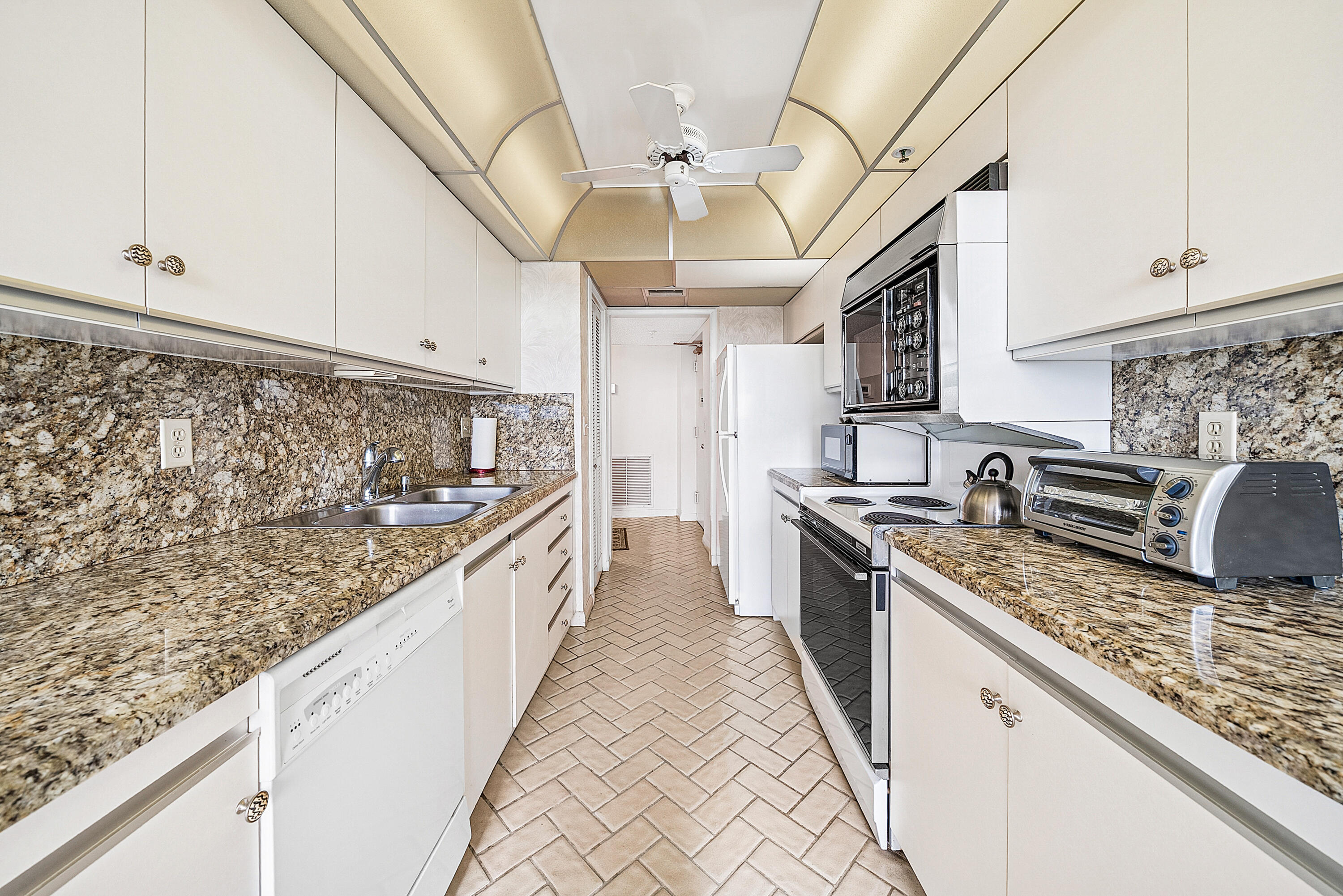 3400 South Ocean Boulevard, Unit 3HI Palm Beach, FL 33480 - Photo 13 of 50 a large kitchen with stainless steel appliances granite countertop a lot of counter space and wooden floors