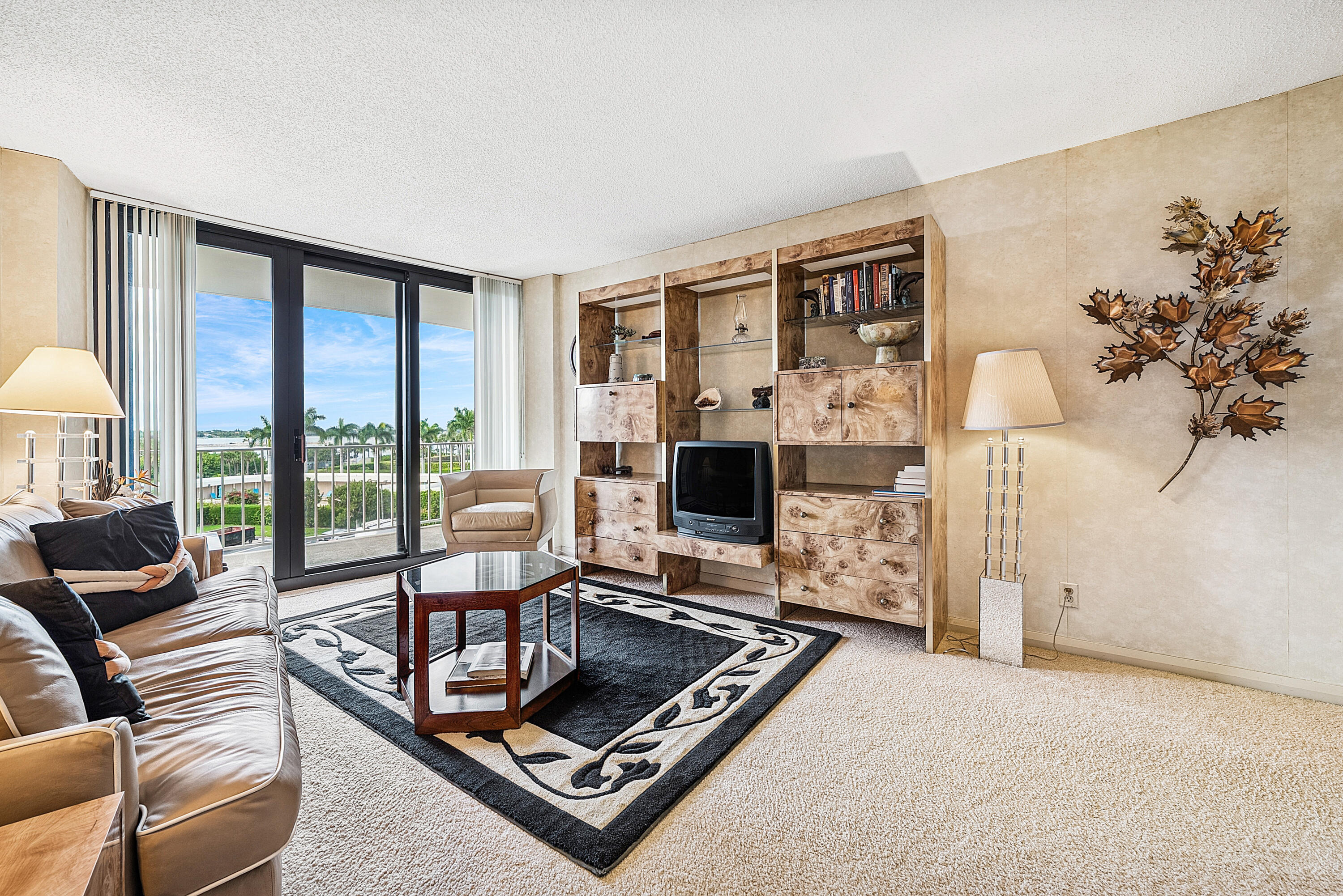 3400 South Ocean Boulevard, Unit 3HI Palm Beach, FL 33480 - Photo 23 of 50 a living room with furniture flat screen tv and a floor to ceiling window