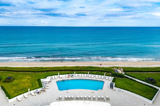 a view of building with swimming pool and outdoor seating