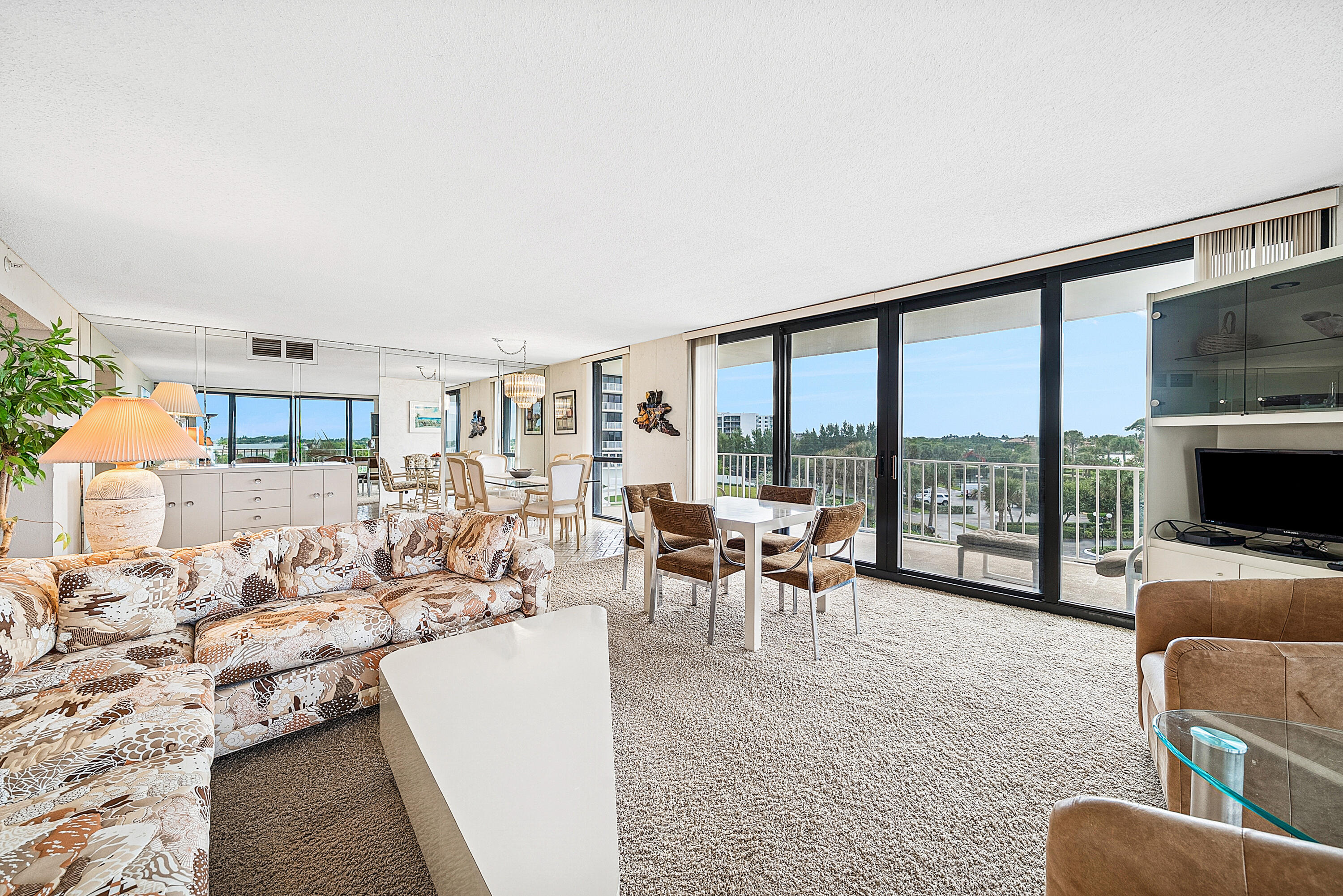 3400 South Ocean Boulevard, Unit 3HI Palm Beach, FL 33480 - Photo 5 of 50 a living room with furniture and a flat screen tv