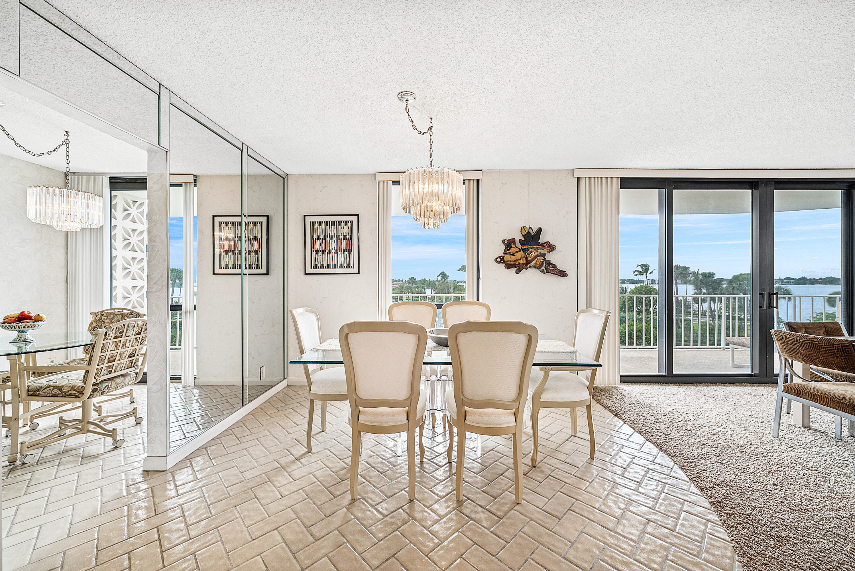 3400 South Ocean Boulevard, Unit 3HI Palm Beach, FL 33480 - Photo 9 of 50 a dining room with furniture a chandelier and wooden floor