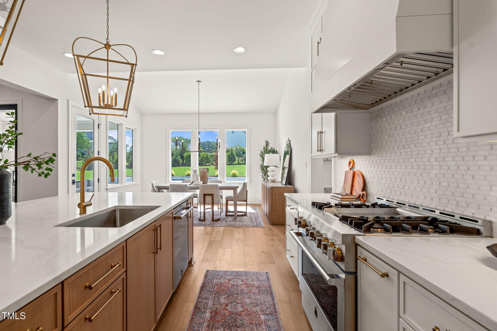 1608 Legacy Ridge Lane Wake Forest, NC 27587 - Photo 18 of 74 a kitchen with a stove a sink and a refrigerator