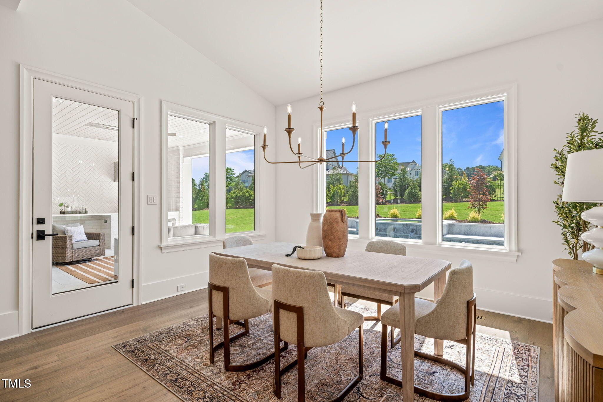 1608 Legacy Ridge Lane Wake Forest, NC 27587 - Photo 21 of 74 a view of a dining room with furniture large windows and wooden floor
