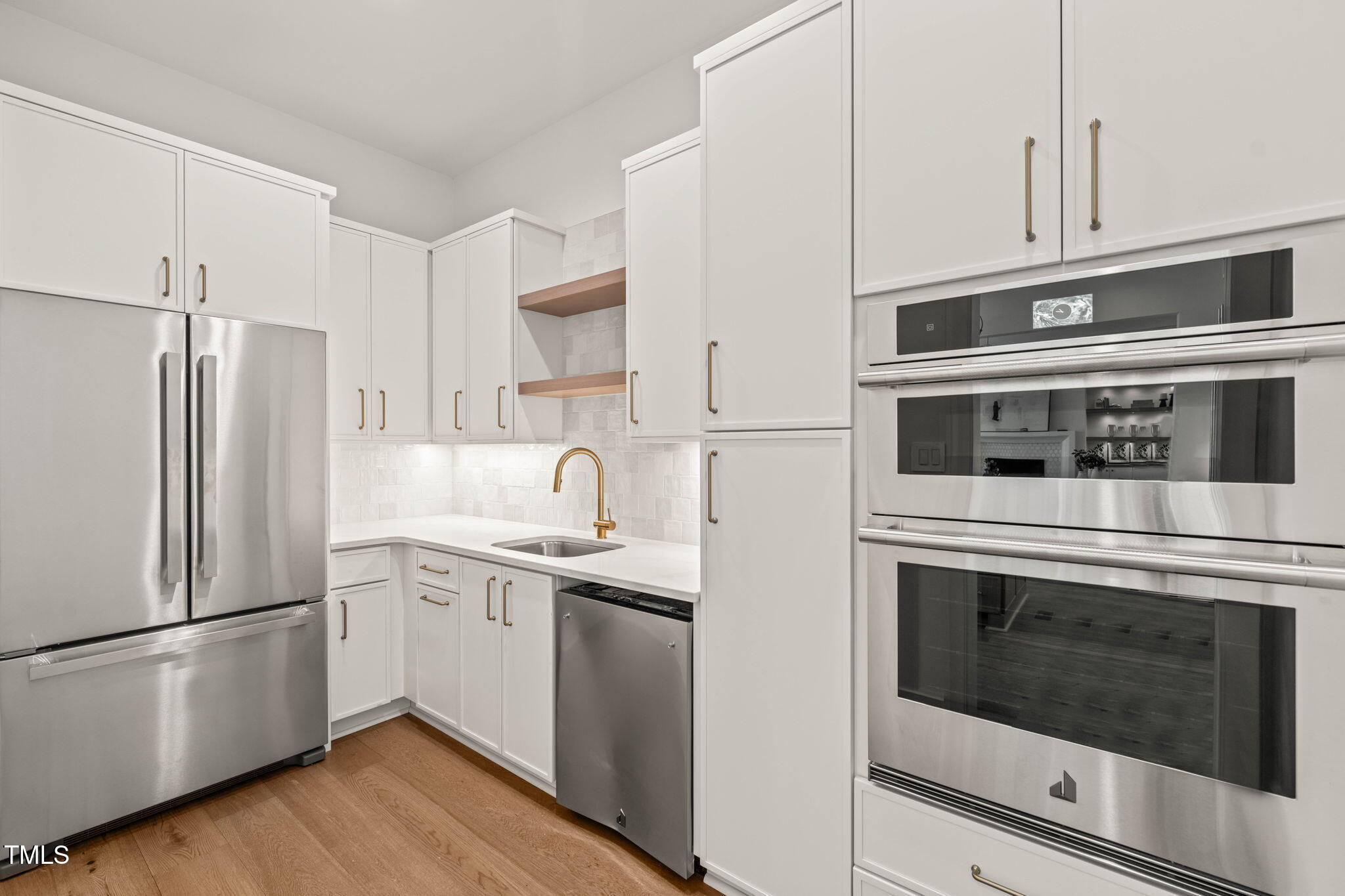 1608 Legacy Ridge Lane Wake Forest, NC 27587 - Photo 22 of 74 a kitchen with stainless steel appliances and white cabinets
