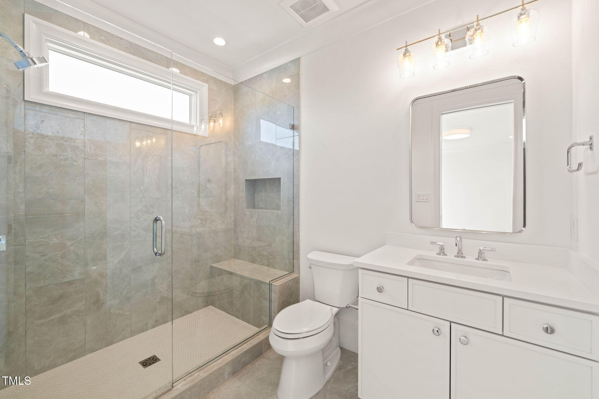 1608 Legacy Ridge Lane Wake Forest, NC 27587 - Photo 49 of 74 a bathroom with a sink a toilet and shower