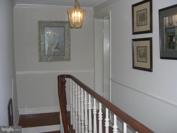 13575 Pleasantville Road Baldwin, MD 21013 - Photo 17 of 21 a view of a hallway with wooden floor and staircase