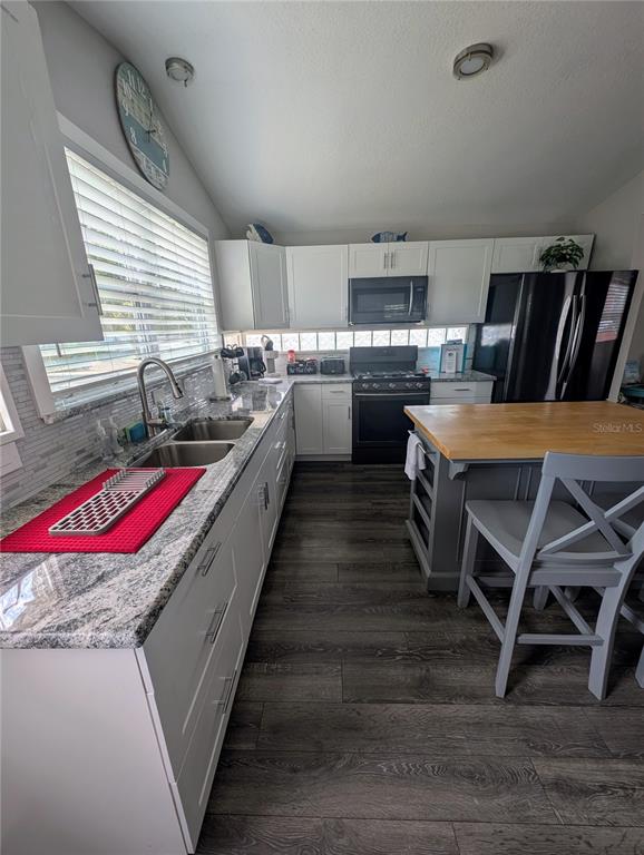 2190 South Seaport Point Crystal River, FL 34429 - Photo 11 of 40 a kitchen with kitchen island granite countertop lots of wooden cabinets a sink and a dishwasher