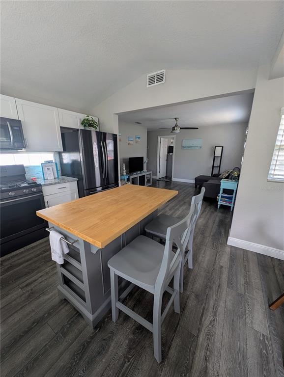 2190 South Seaport Point Crystal River, FL 34429 - Photo 13 of 40 a dining room with a table chairs and kitchen view