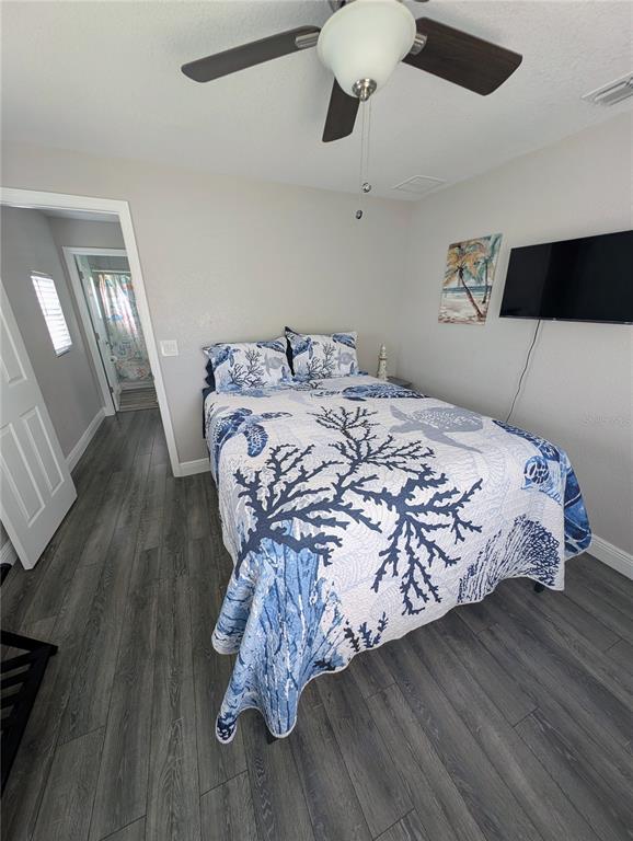 2190 South Seaport Point Crystal River, FL 34429 - Photo 16 of 40 a bedroom with a bed and wooden floor