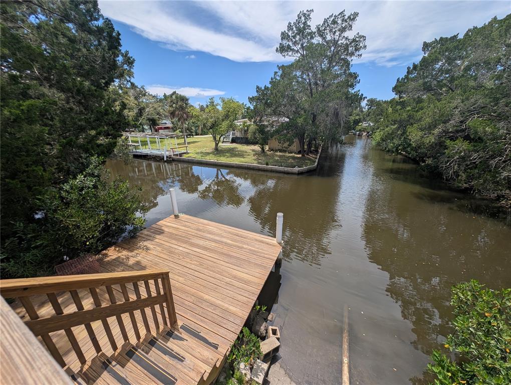 2190 South Seaport Point Crystal River, FL 34429 - Photo 36 of 40 a wooden pier with boats and trees in the background