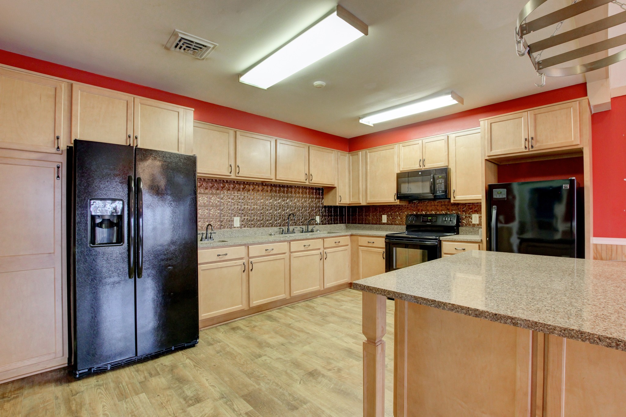 901 Martin Street Clarksville, TN 37040 - Photo 5 of 52 a kitchen with granite countertop a refrigerator and a stove top oven