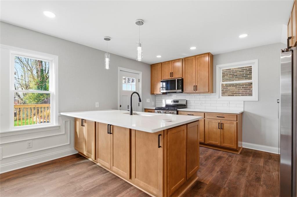 2214 Saranac Avenue Pittsburgh, PA 15216 - Photo 11 of 39 a kitchen with stainless steel appliances granite countertop a sink a stove a refrigerator cabinets and a window