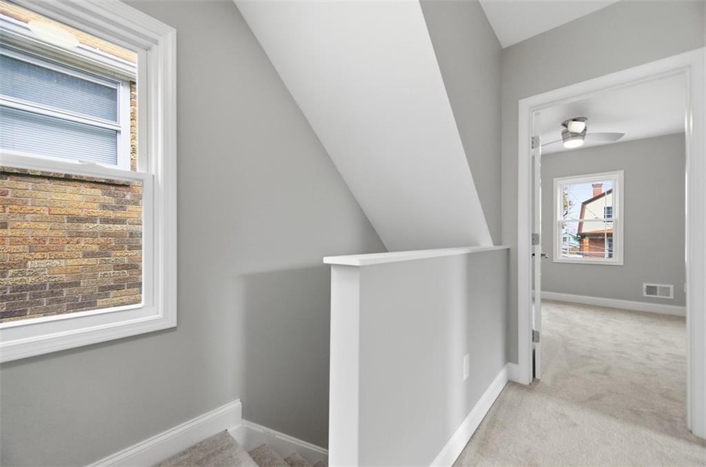 2214 Saranac Avenue Pittsburgh, PA 15216 - Photo 17 of 39 a view of hallway with stairs and wooden floor