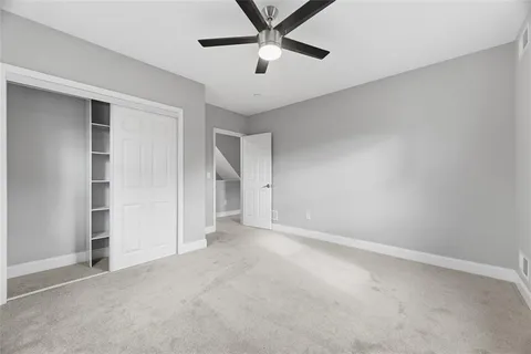 an empty room with closet and windows