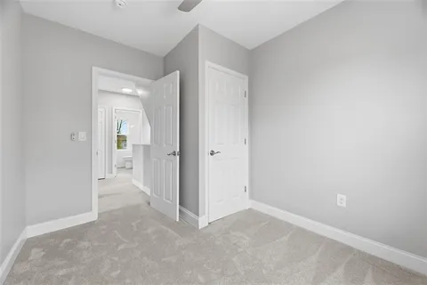 an empty room with mirror in a kitchen