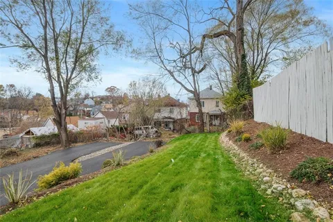 a backyard of a house with table and chairs