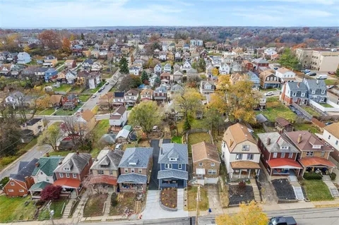 an aerial view of residential houses with outdoor space