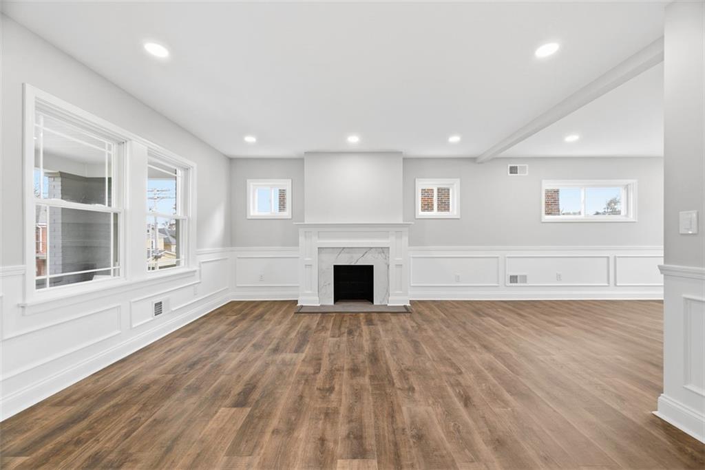 2214 Saranac Avenue Pittsburgh, PA 15216 - Photo 5 of 39 an empty room with wooden floor fireplace and windows