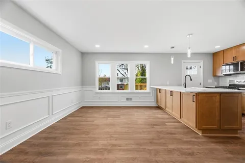 a large white kitchen with a large window