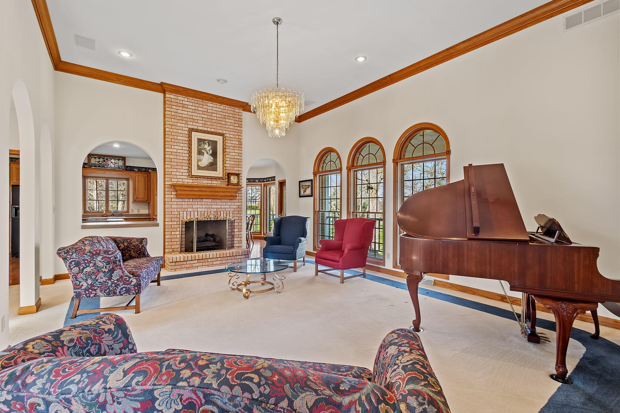 6664 Ridgeview Drive Demotte, IN 46310 - Photo 15 of 65 a living room with furniture a fireplace and a chandelier