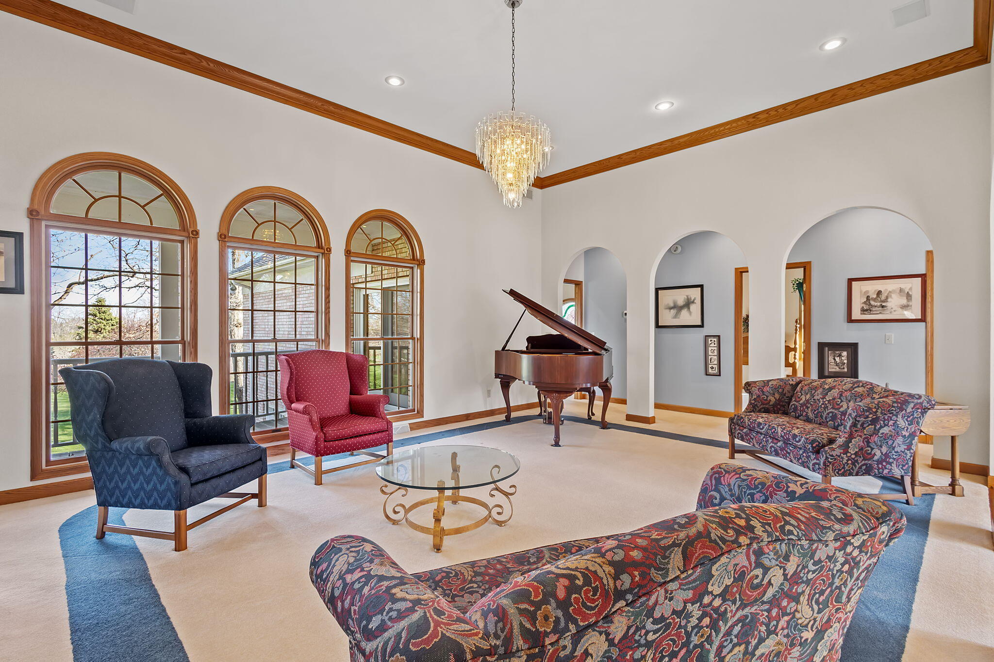 6664 Ridgeview Drive Demotte, IN 46310 - Photo 16 of 65 a living room with furniture a rug and a chandelier