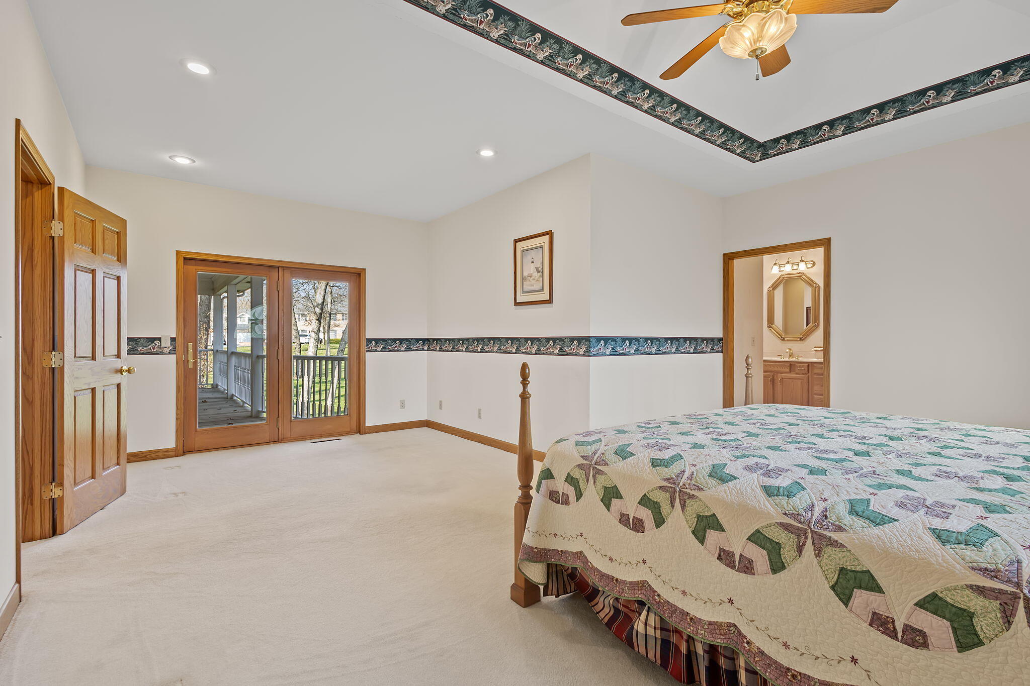 6664 Ridgeview Drive Demotte, IN 46310 - Photo 20 of 65 a bedroom with a large bed and a chandelier