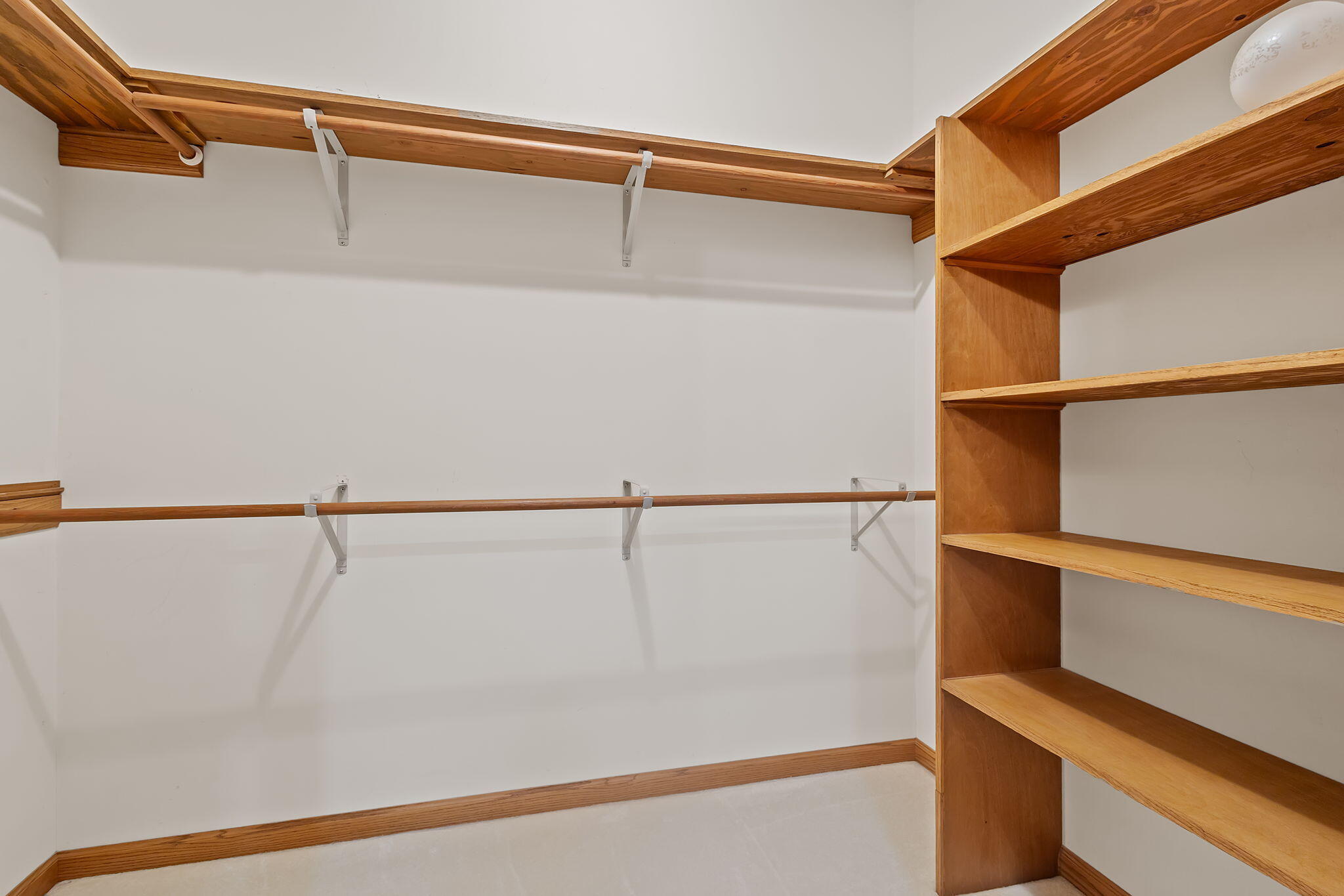 6664 Ridgeview Drive Demotte, IN 46310 - Photo 25 of 65 a view of walk in closet with clothes and shoes