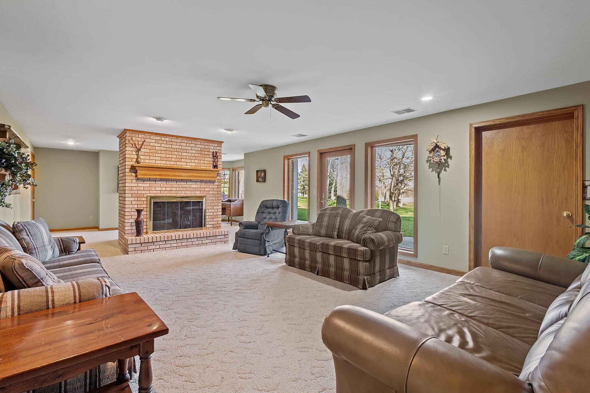 6664 Ridgeview Drive Demotte, IN 46310 - Photo 35 of 65 a living room with furniture ceiling fan and a fireplace