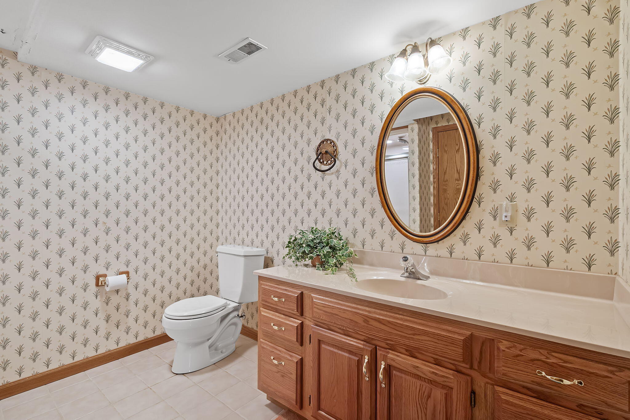 6664 Ridgeview Drive Demotte, IN 46310 - Photo 42 of 65 a bathroom with a granite countertop toilet a sink and a mirror