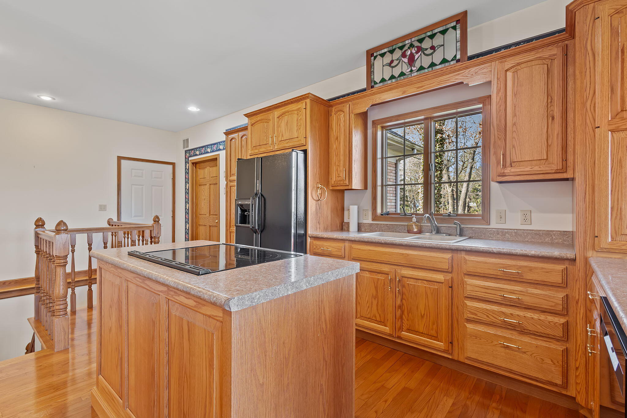 6664 Ridgeview Drive Demotte, IN 46310 - Photo 6 of 65 a kitchen with stainless steel appliances granite countertop a sink and a refrigerator