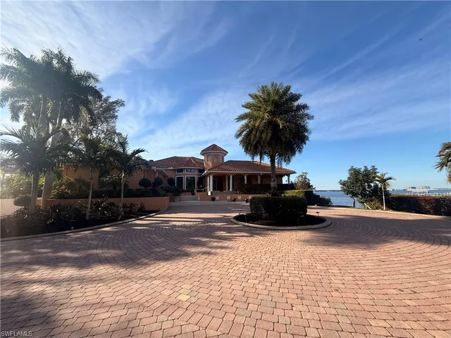 a large tree in front of a house