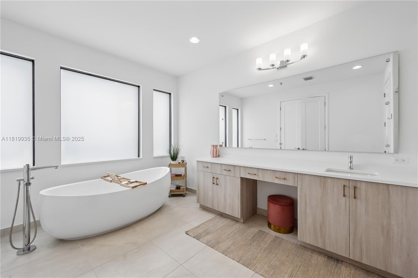 20273 Bandon Dunes Road Boca Raton, FL 33434 - Photo 54 of 73 a spacious bathroom with a tub a double vanity sink a window and mirror