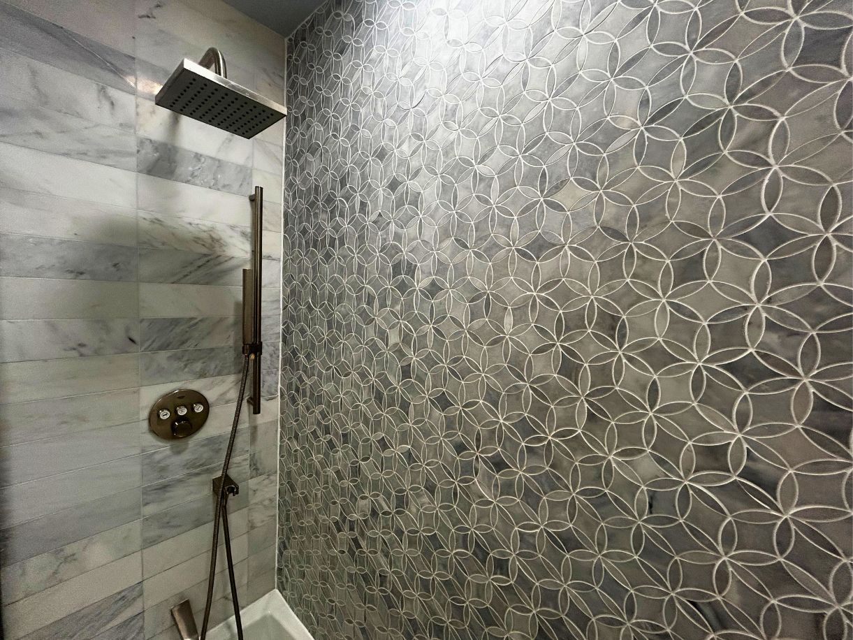 8210 Bent Tree Road, Unit 247 Austin, TX 78759 - Photo 8 of 21 The shower features a rain showerhead, a handheld shower, and a decorative tiled wall with a geometric pattern