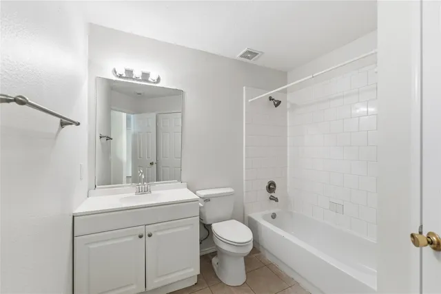 a bathroom with a bathtub shower sink mirror and toilet