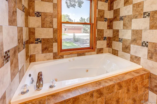 a bath tub sitting next to a window