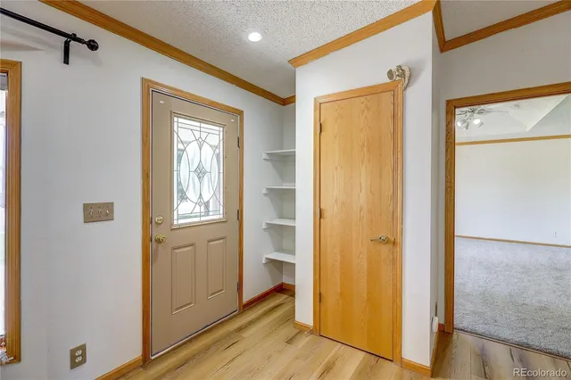 a view of a hallway with wooden floor and closet