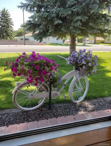 a view of a wooden bench sitting in front of a house
