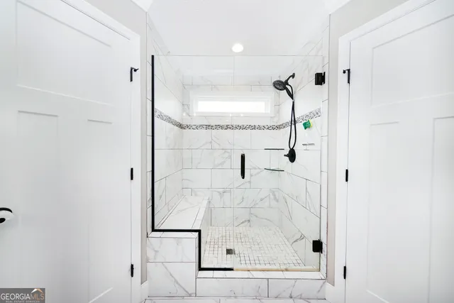 a bathroom with a glass shower door