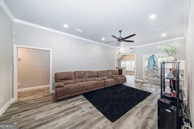 a living room with furniture and wooden floor