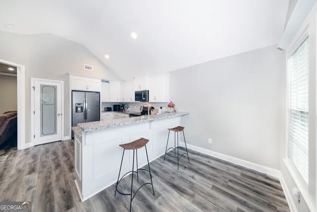 a kitchen with stainless steel appliances a refrigerator and microwave